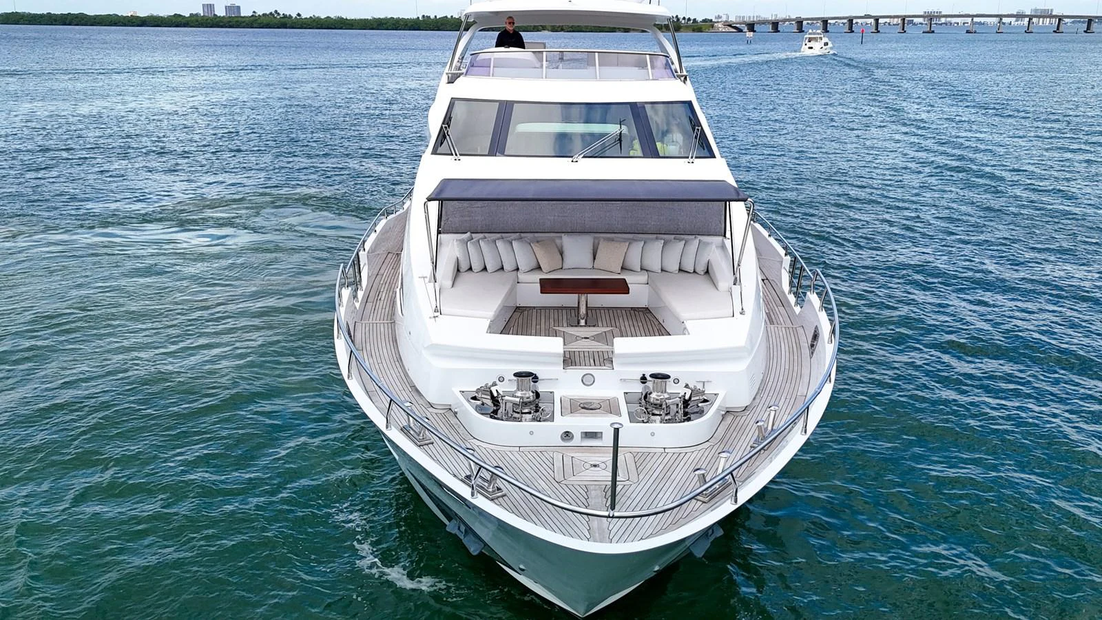 A luxurious yacht cruising on calm waters with a spacious and inviting bow seating area. aboard 2017 AZIMUT 30 METRI Yacht for Sale