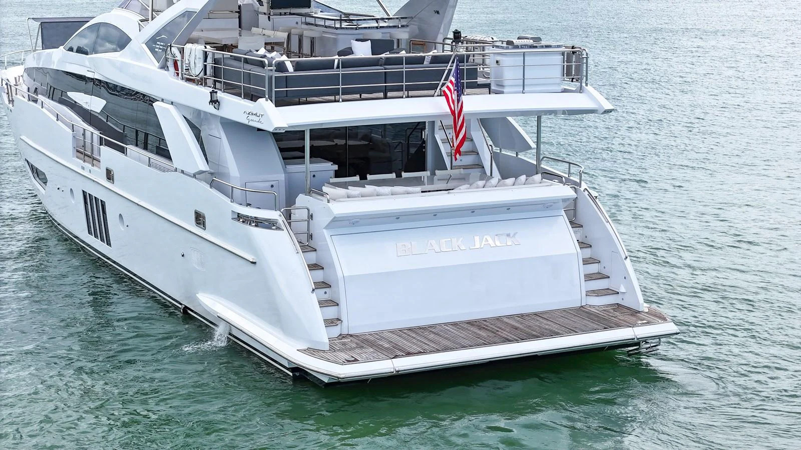 The yacht's sleek aft deck features a spacious swim platform and elegant design elements. aboard 2017 AZIMUT 30 METRI Yacht for Sale