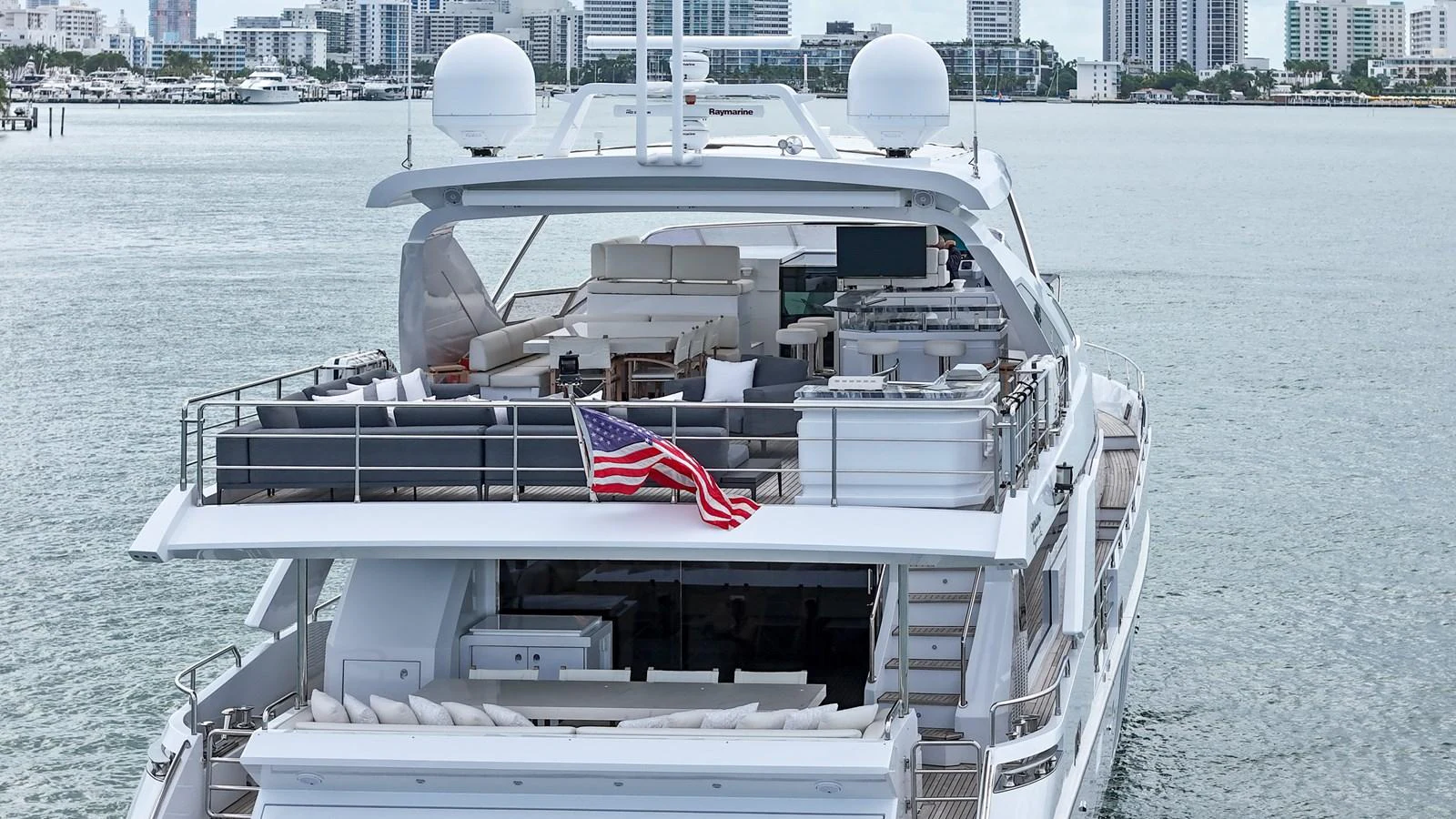 The yacht's aft deck offers a spacious and luxurious outdoor living area with ample seating and amenities. aboard 2017 AZIMUT 30 METRI Yacht for Sale