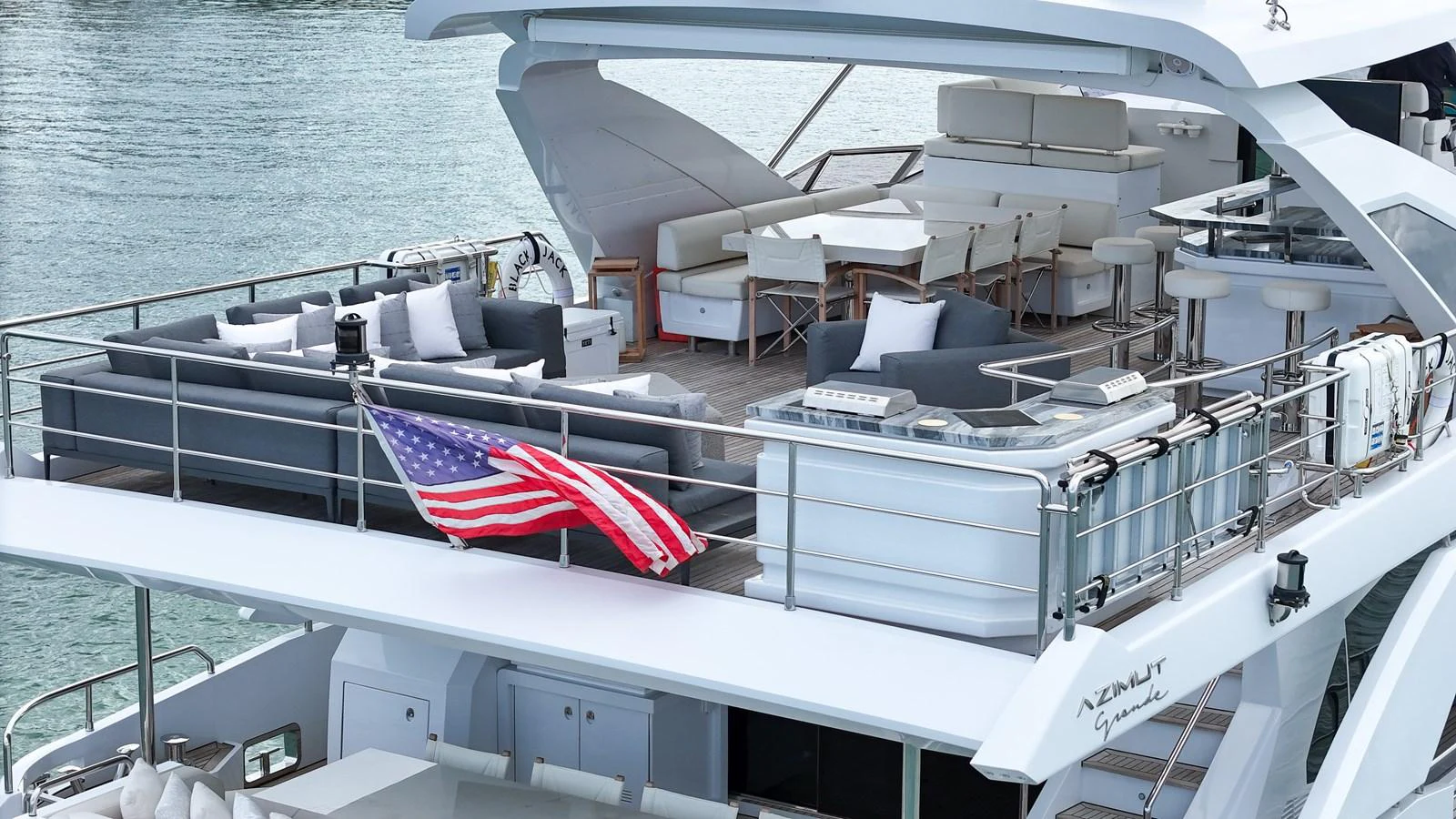 The flybridge offers a spacious and luxurious outdoor living area with ample seating and dining options. aboard 2017 AZIMUT 30 METRI Yacht for Sale