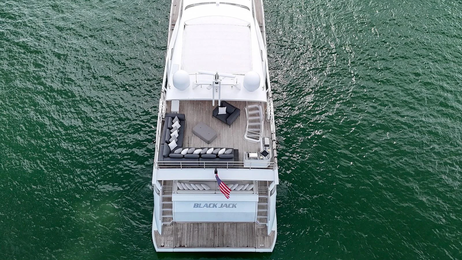 The yacht's aft deck features a spacious lounging area with comfortable seating and a view of the water. aboard 2017 AZIMUT 30 METRI Yacht for Sale