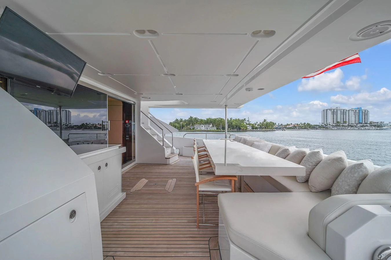 The aft deck features a spacious seating area with a large table, perfect for outdoor dining and relaxation. aboard 2017 AZIMUT 30 METRI Yacht for Sale