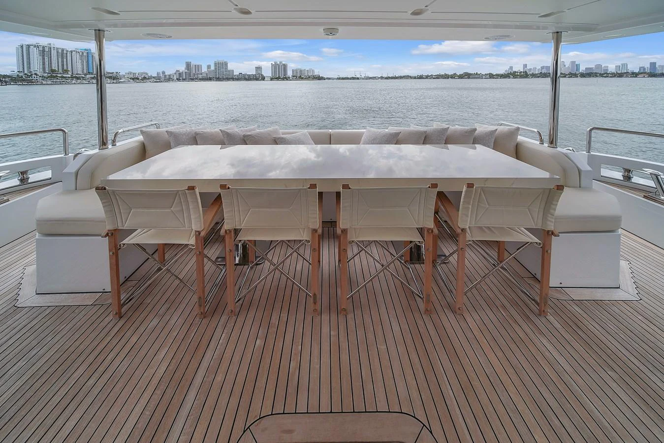 The aft deck features a spacious dining area with a large table and comfortable seating, perfect for enjoying meals with a view. aboard 2017 AZIMUT 30 METRI Yacht for Sale