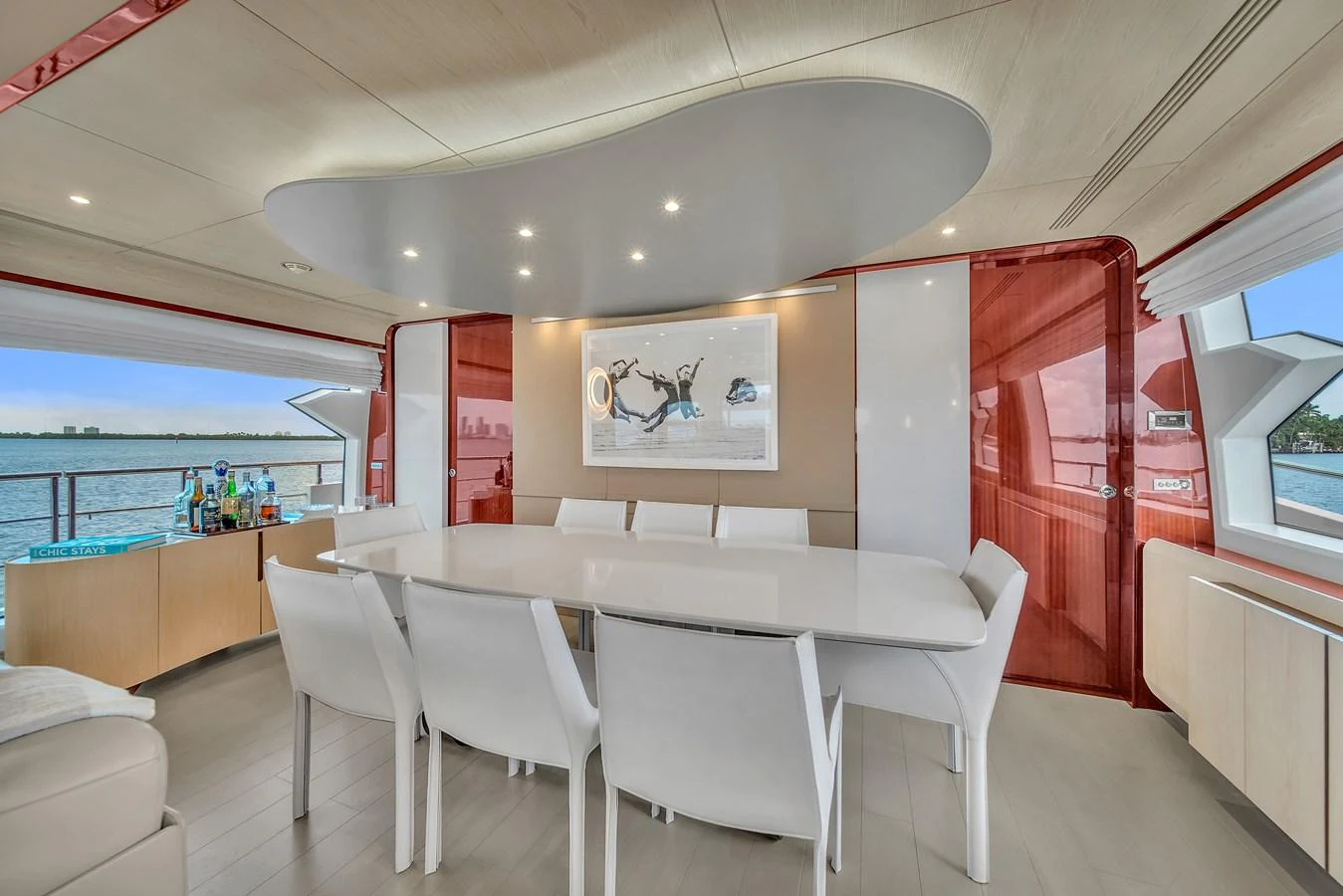 The yacht's dining area features a sleek, modern design with a large table and ample seating, complemented by panoramic views. aboard 2017 AZIMUT 30 METRI Yacht for Sale
