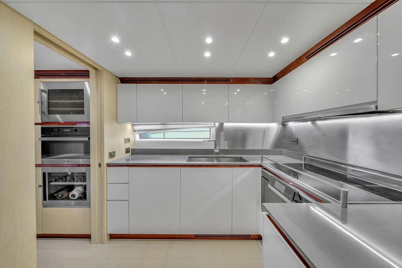 The sleek and modern galley features high-gloss cabinetry and state-of-the-art appliances. aboard 2017 AZIMUT 30 METRI Yacht for Sale