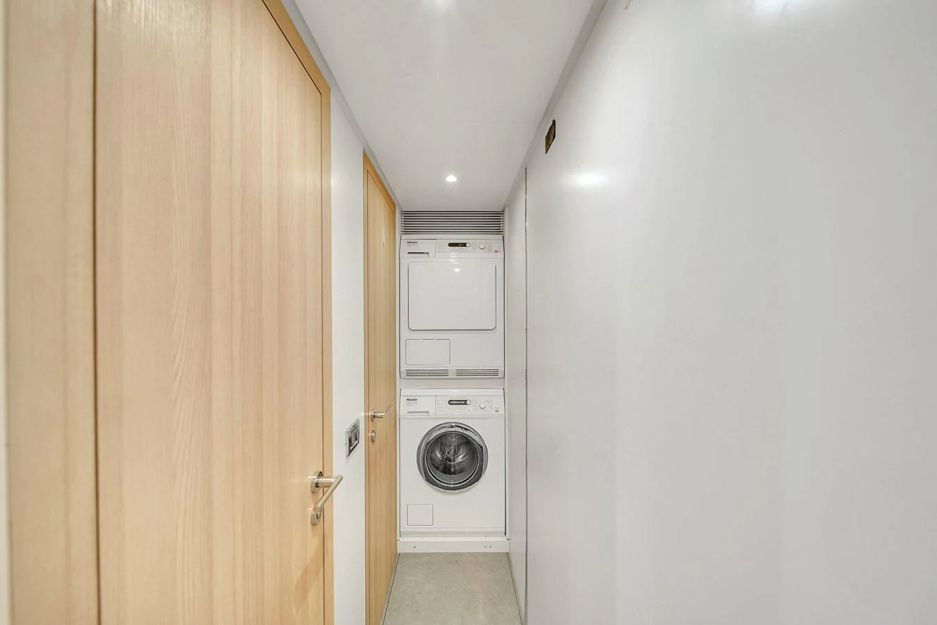 The yacht features a compact and efficient laundry room with modern appliances. aboard 2017 AZIMUT 30 METRI Yacht for Sale