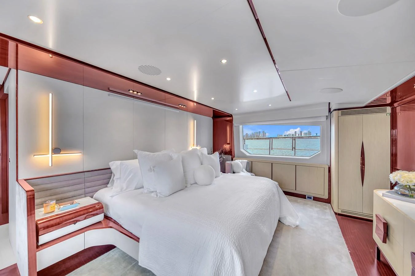 The master stateroom features a luxurious bed with plush pillows and elegant lighting. aboard 2017 AZIMUT 30 METRI Yacht for Sale