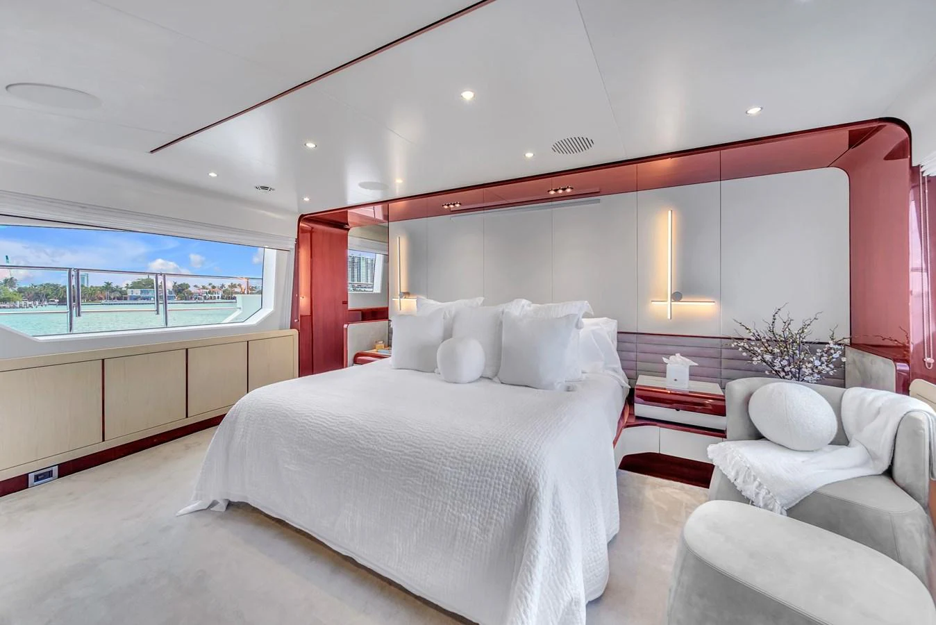 The master stateroom features a spacious bed with luxurious linens and modern decor, offering a serene retreat with a view of the sea. aboard 2017 AZIMUT 30 METRI Yacht for Sale