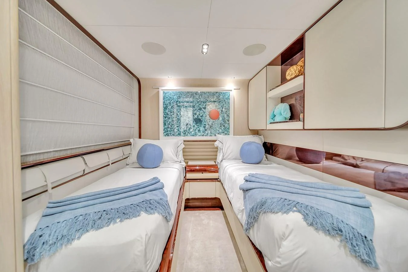 A cozy twin stateroom featuring two single beds with elegant bedding and soft lighting. aboard 2017 AZIMUT 30 METRI Yacht for Sale