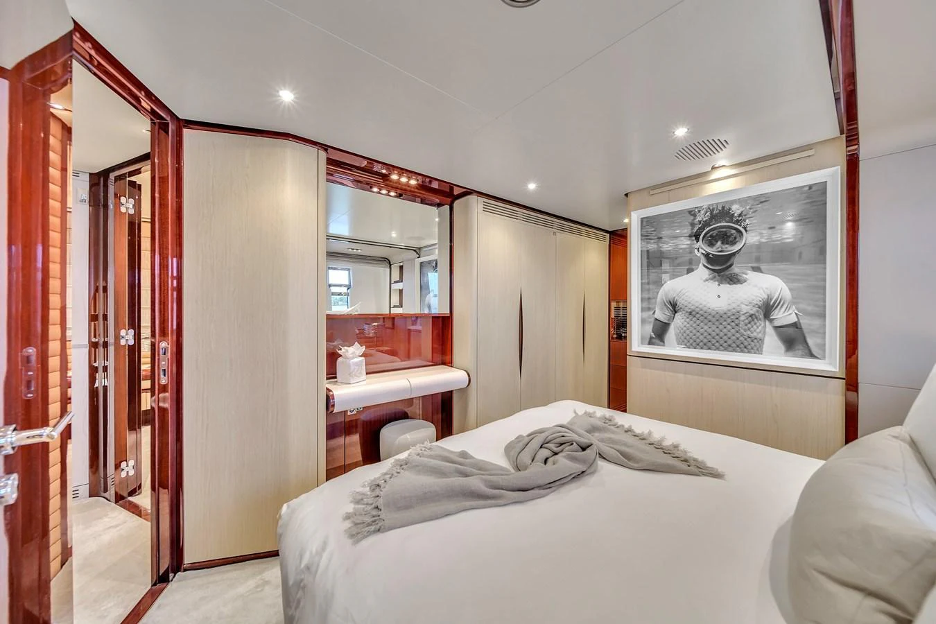 A luxurious stateroom featuring a comfortable bed and elegant wood finishes. aboard 2017 AZIMUT 30 METRI Yacht for Sale