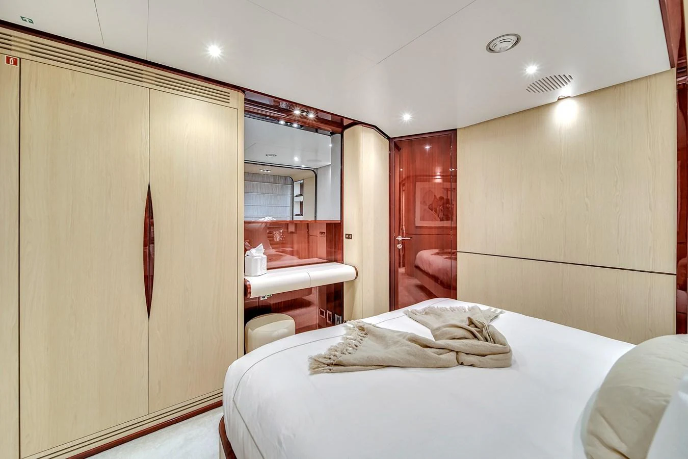 The stateroom features a luxurious bed with elegant wood finishes and ample storage space. aboard 2017 AZIMUT 30 METRI Yacht for Sale