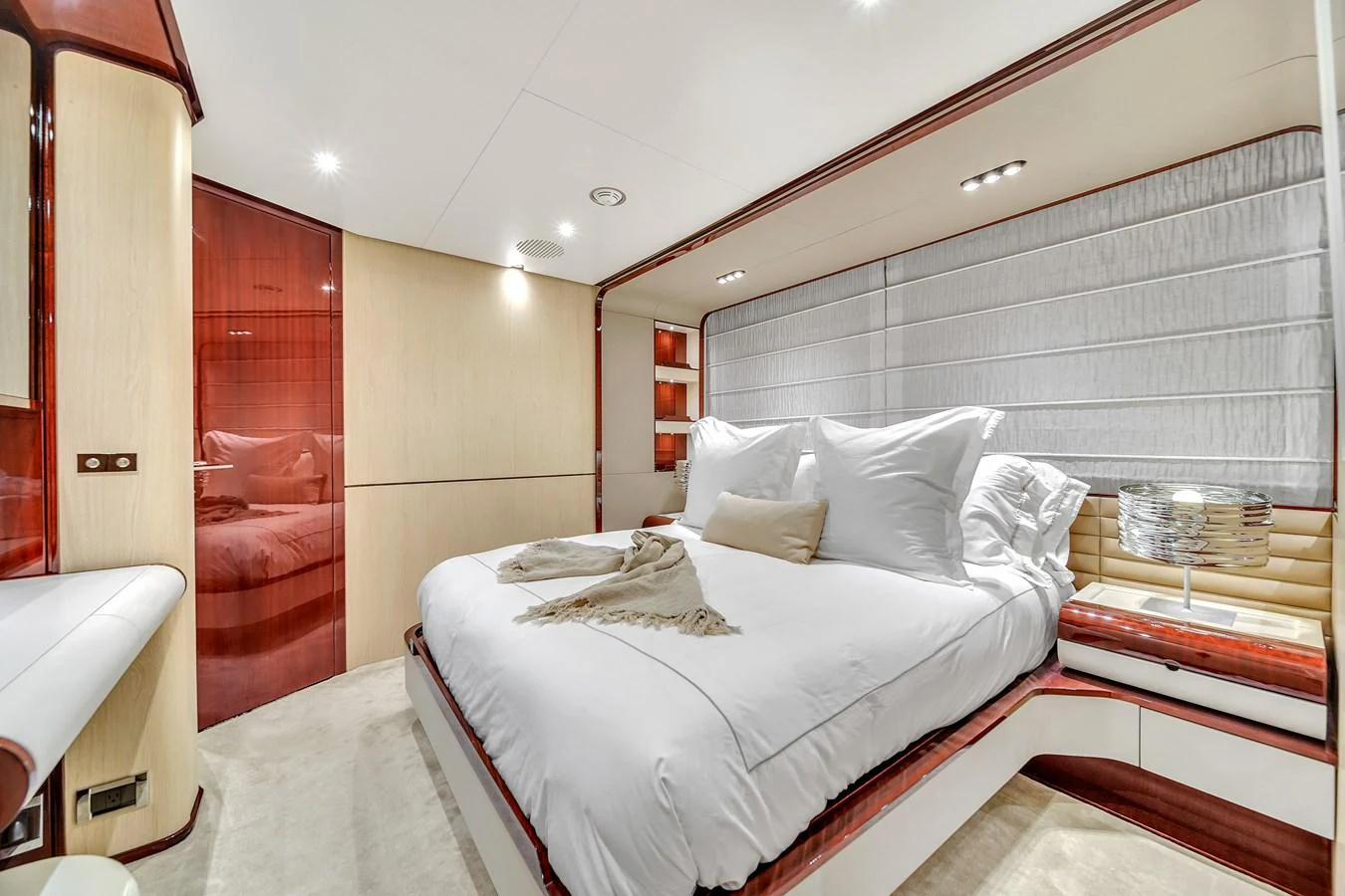 The stateroom features a luxurious bed with plush linens and elegant wood accents. aboard 2017 AZIMUT 30 METRI Yacht for Sale
