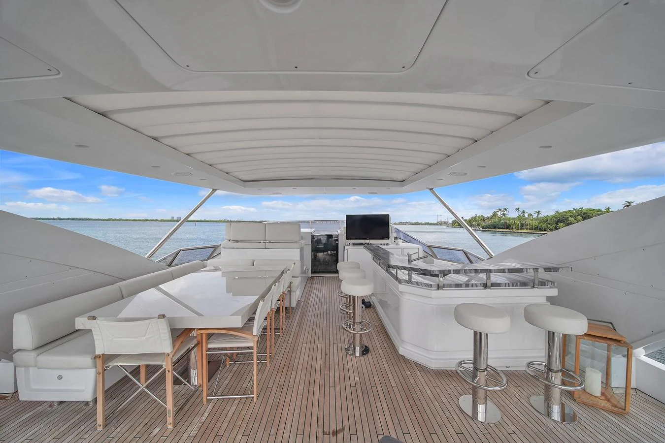 The flybridge features a spacious dining area and a sleek bar with panoramic views. aboard 2017 AZIMUT 30 METRI Yacht for Sale