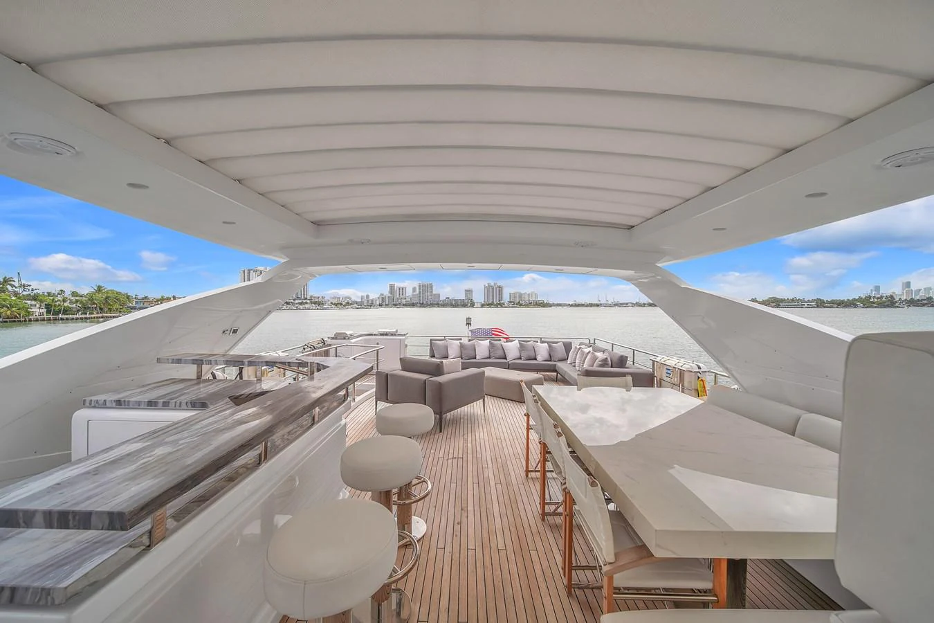The aft deck offers a spacious and luxurious seating area with a stunning view of the water. aboard 2017 AZIMUT 30 METRI Yacht for Sale