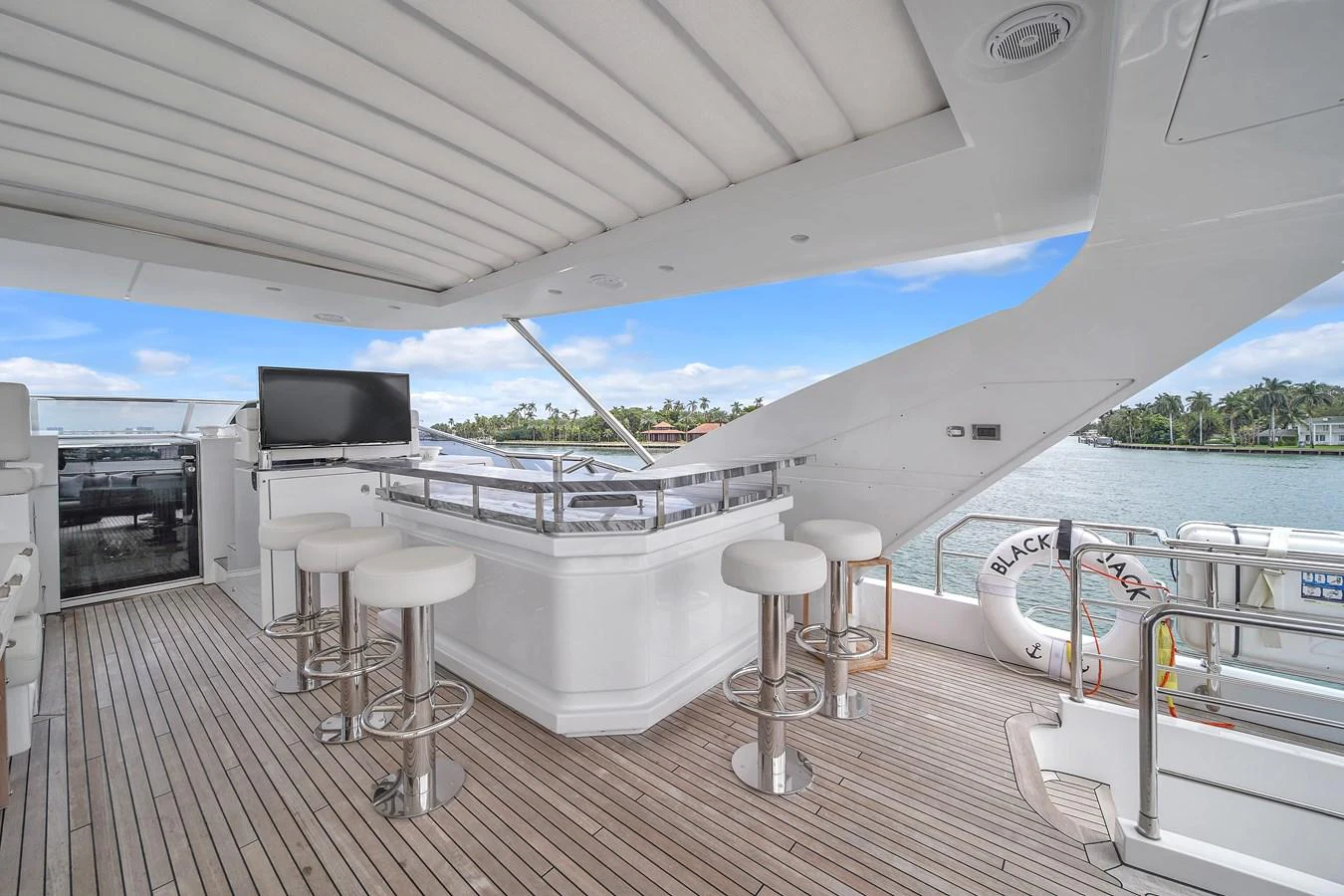 The flybridge offers a spacious and inviting area with bar seating and panoramic views. aboard 2017 AZIMUT 30 METRI Yacht for Sale