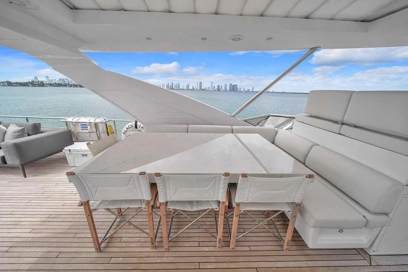 The aft deck offers a spacious and comfortable seating area with a stunning view of the water and city skyline. aboard 2017 AZIMUT 30 METRI Yacht for Sale