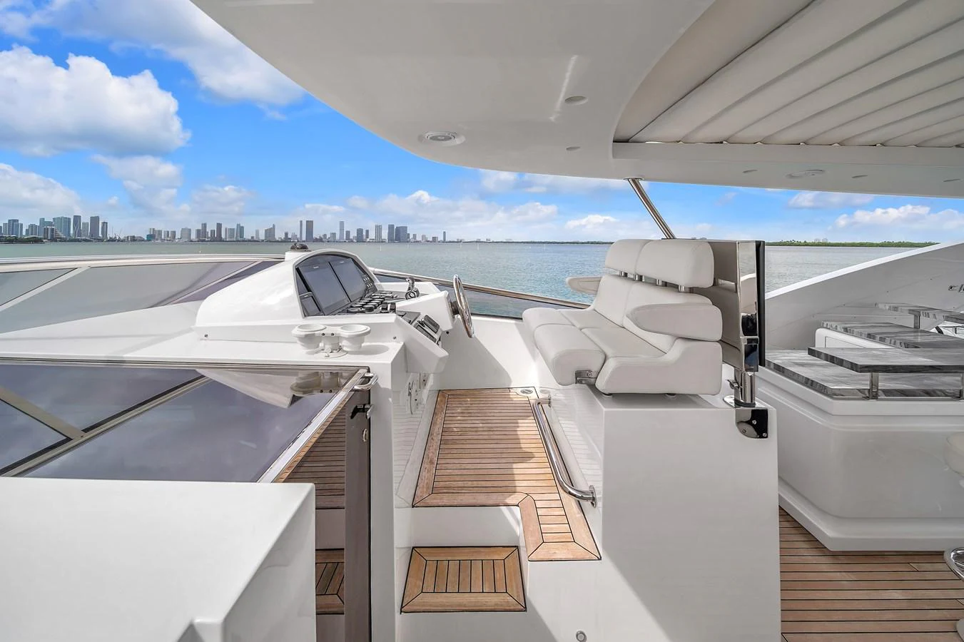 The flybridge offers a spacious and luxurious area for relaxation with stunning views of the water and skyline. aboard 2017 AZIMUT 30 METRI Yacht for Sale