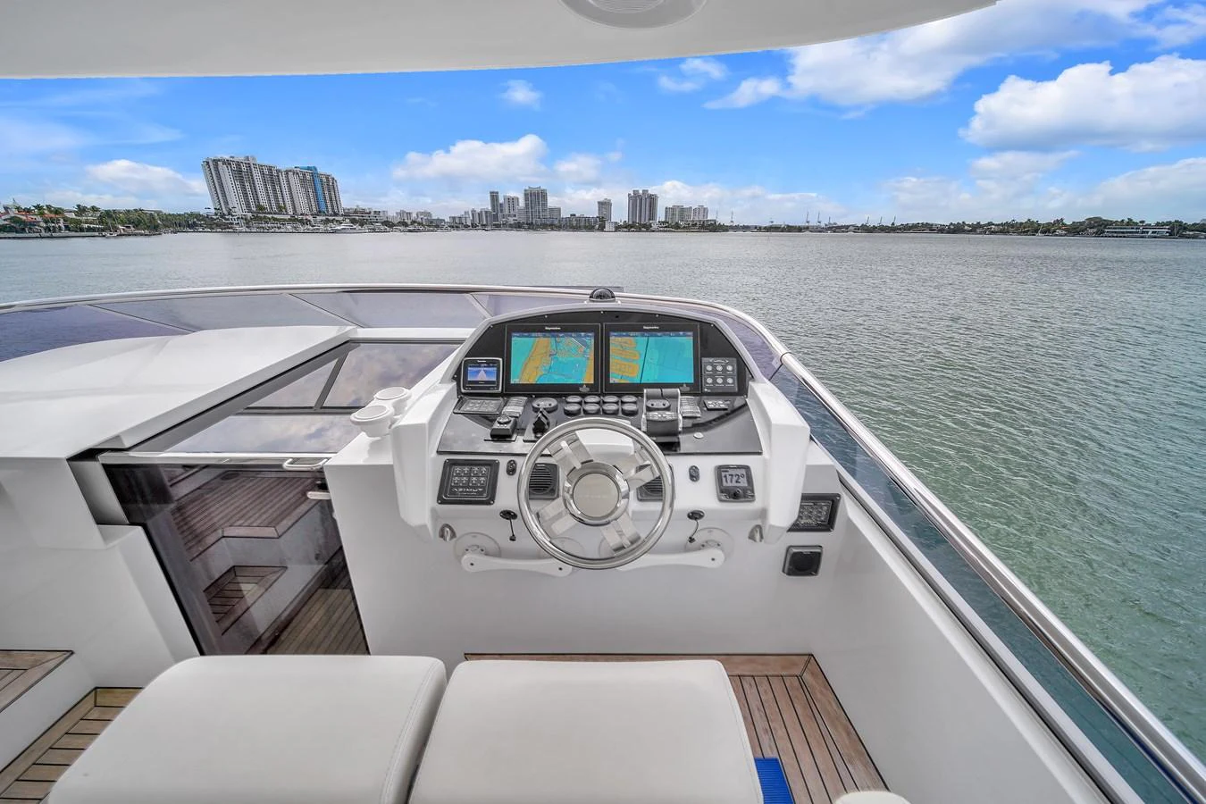 The helm station offers a commanding view of the water and skyline, equipped with advanced navigation systems. aboard 2017 AZIMUT 30 METRI Yacht for Sale