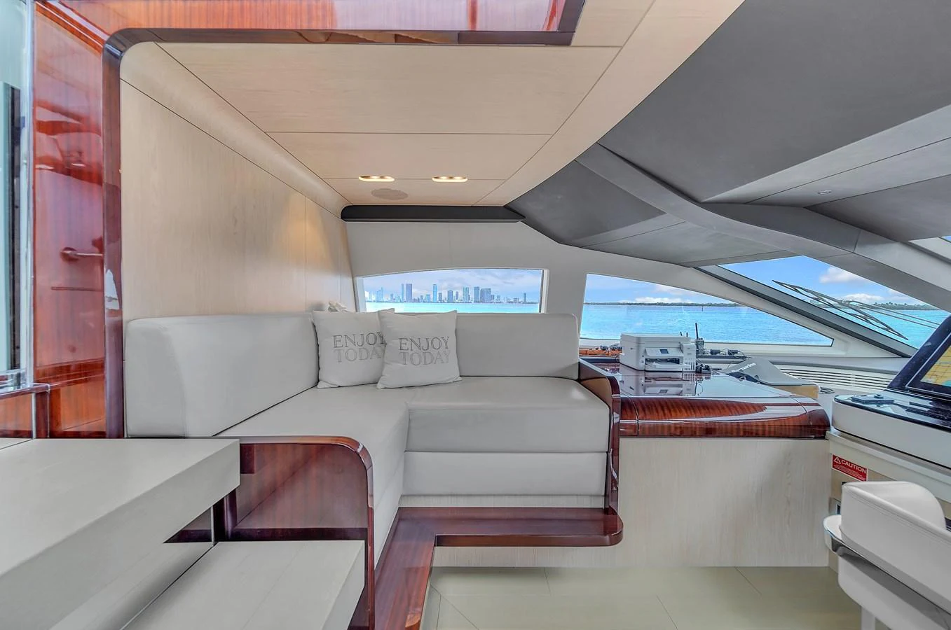 The salon offers a comfortable seating area with a view of the water through large windows. aboard 2017 AZIMUT 30 METRI Yacht for Sale
