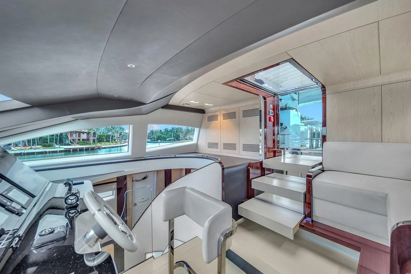 The helm station features modern controls and a comfortable seating area with a view of the water. aboard 2017 AZIMUT 30 METRI Yacht for Sale