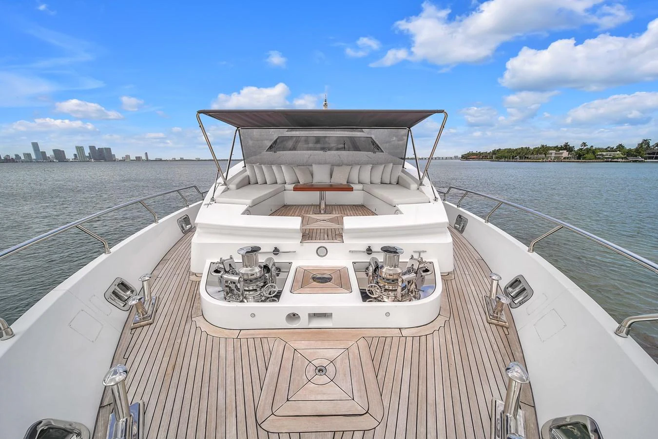 The foredeck features a spacious sunbathing area with plush seating and a retractable sunshade. aboard 2017 AZIMUT 30 METRI Yacht for Sale