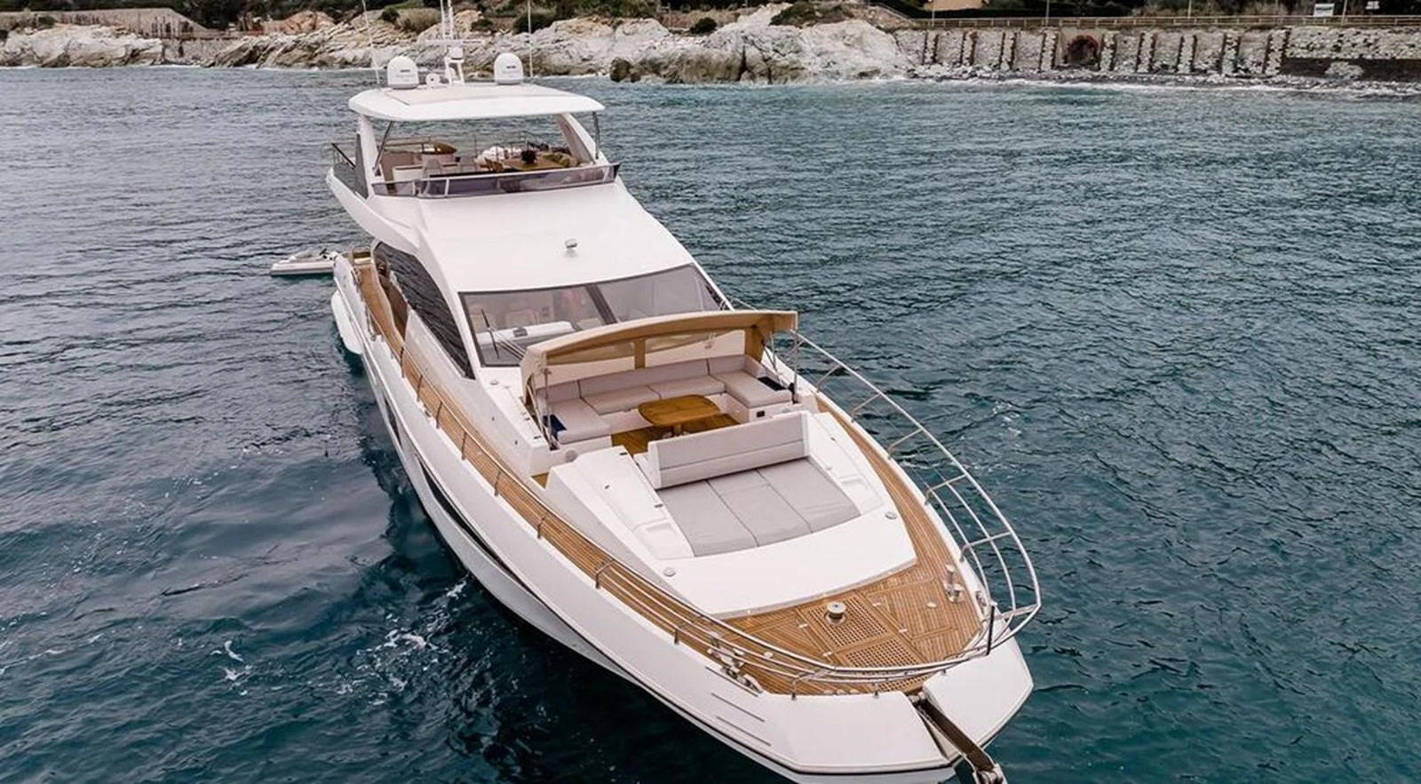 A sleek and modern yacht cruising on calm waters with a spacious deck and luxurious amenities. aboard LASTOCHKA Yacht for Sale