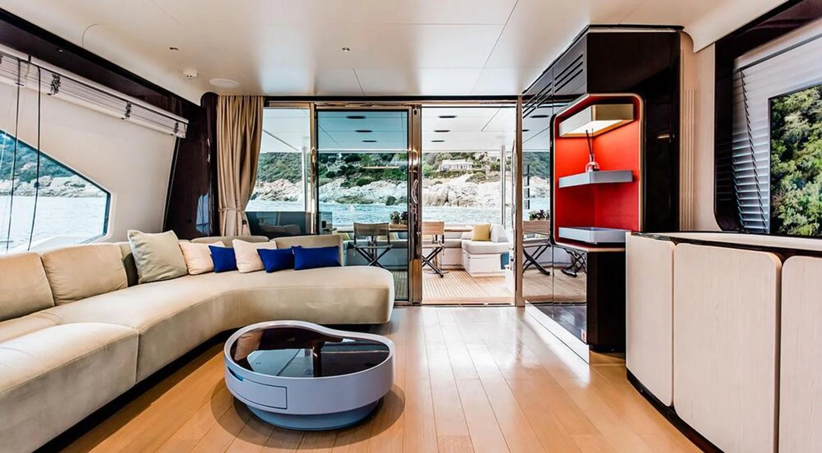 The salon features a spacious and modern design with large windows offering stunning views. aboard LASTOCHKA Yacht for Sale