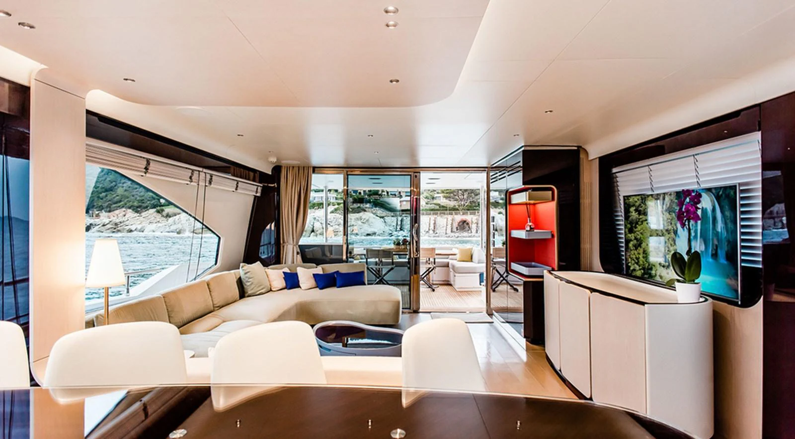 The spacious salon features elegant furnishings and panoramic windows offering stunning views. aboard LASTOCHKA Yacht for Sale