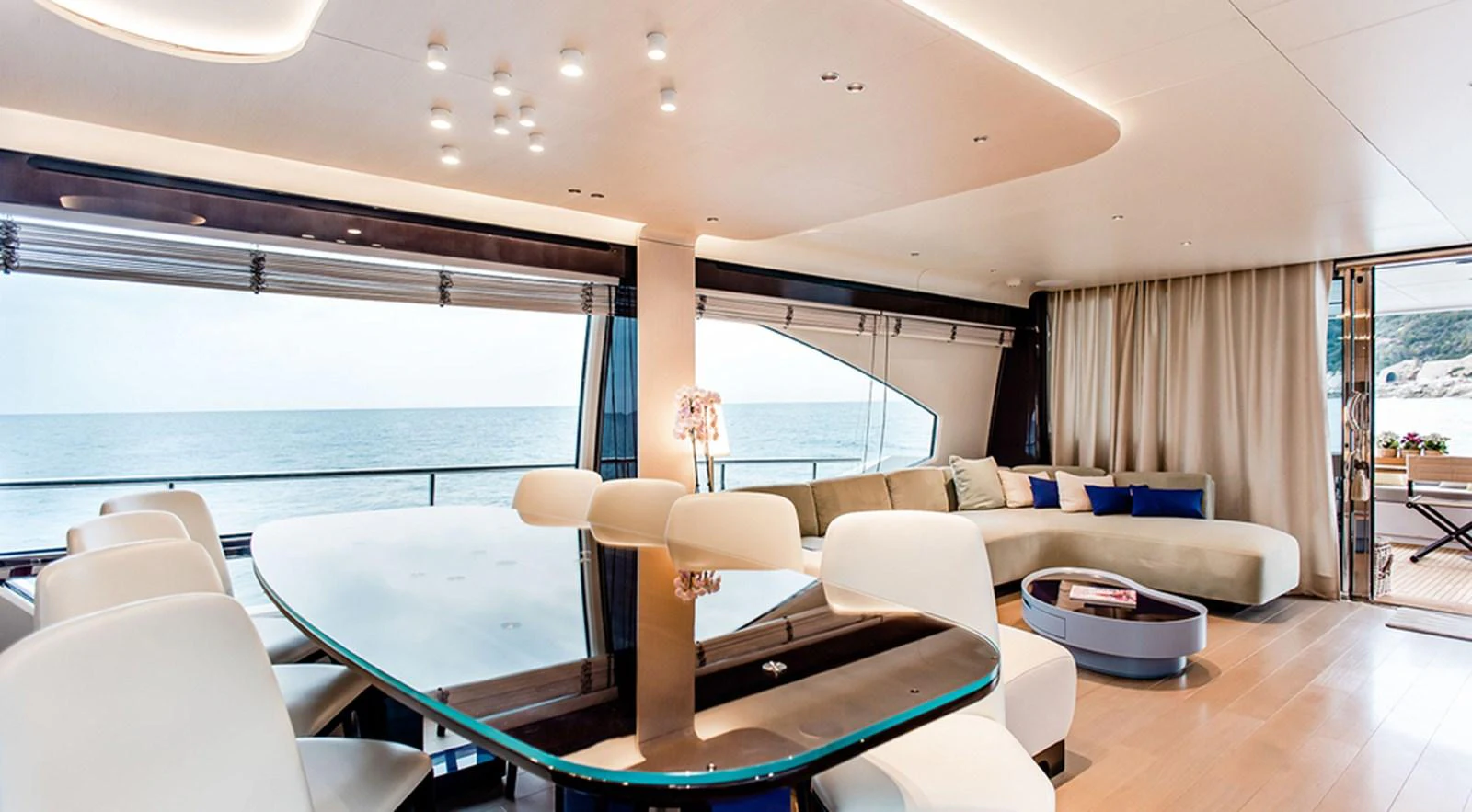 The yacht's salon features a spacious and elegant seating area with panoramic ocean views. aboard LASTOCHKA Yacht for Sale