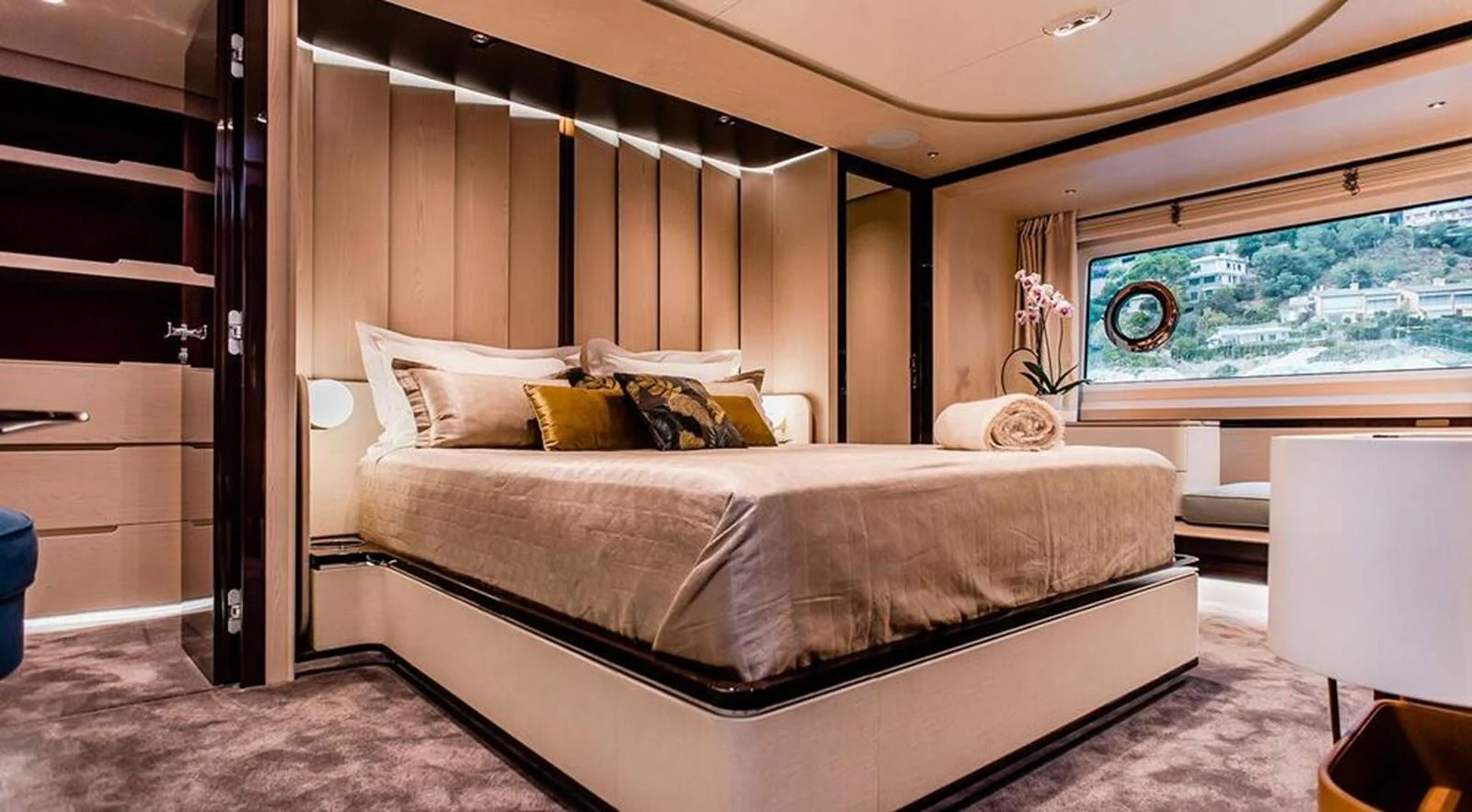 The master stateroom features a luxurious bed with elegant decor and a scenic view through the window. aboard LASTOCHKA Yacht for Sale