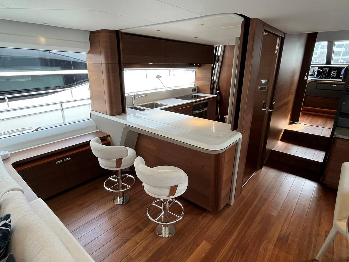 The yacht's galley features modern wood finishes and sleek countertops, creating a warm and inviting space. aboard LILYAN Yacht for Sale