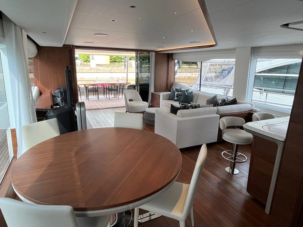 The salon features a spacious seating area with modern furnishings and large windows offering ample natural light. aboard LILYAN Yacht for Sale