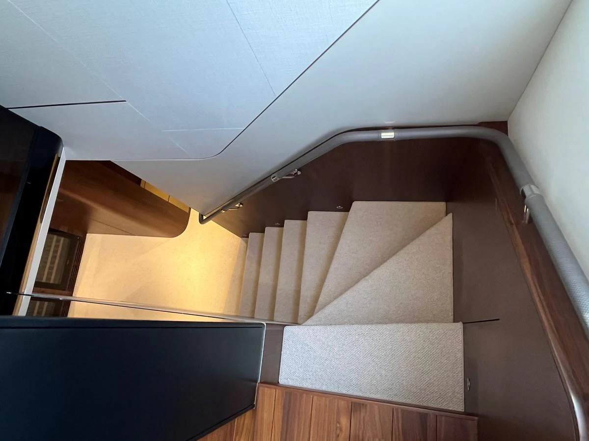 A well-designed staircase with modern finishes connects different levels of the yacht's interior. aboard LILYAN Yacht for Sale
