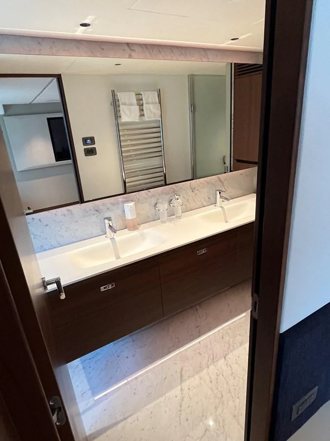 The yacht's bathroom features a sleek, modern design with dual sinks and elegant fixtures. aboard LILYAN Yacht for Sale