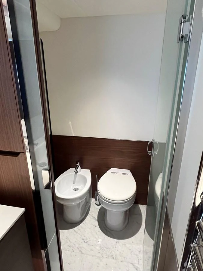 The yacht's head features a modern toilet and bidet with sleek finishes. aboard LILYAN Yacht for Sale