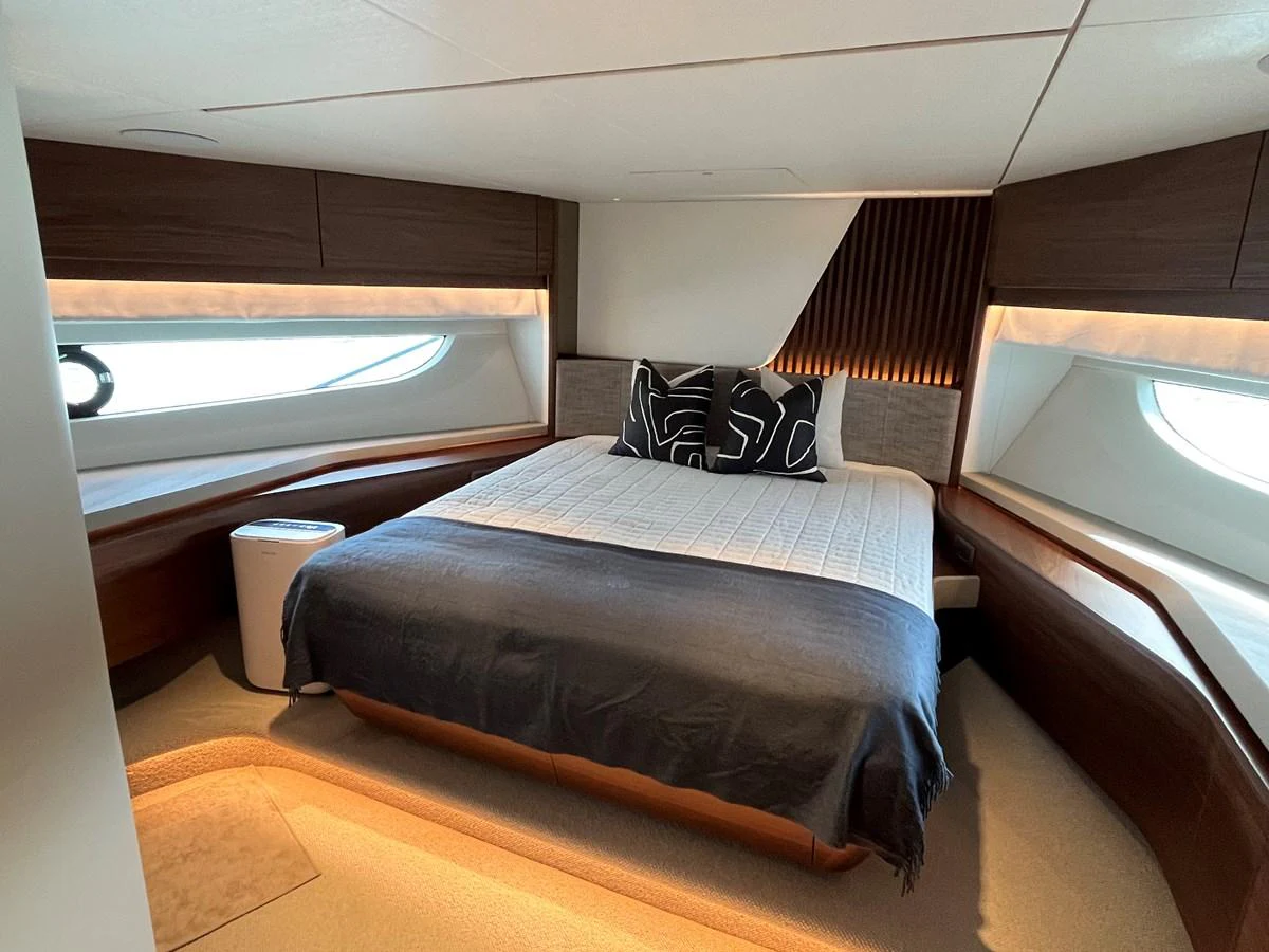 The stateroom features a luxurious bed with modern decor and ample natural light. aboard LILYAN Yacht for Sale