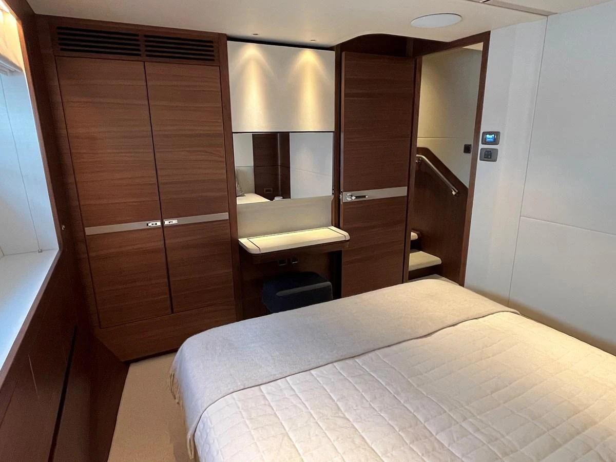 A cozy stateroom featuring a comfortable bed and elegant wooden cabinetry. aboard LILYAN Yacht for Sale