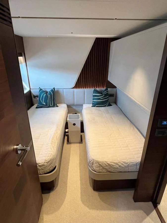 A cozy twin stateroom with modern decor and comfortable bedding. aboard LILYAN Yacht for Sale