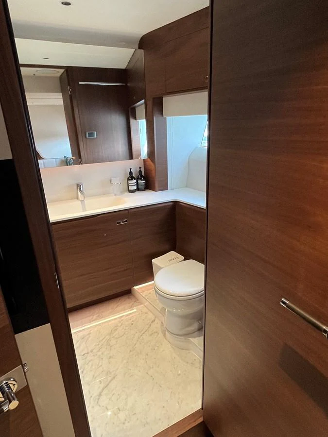The yacht's bathroom features sleek wooden cabinetry and a modern design. aboard LILYAN Yacht for Sale