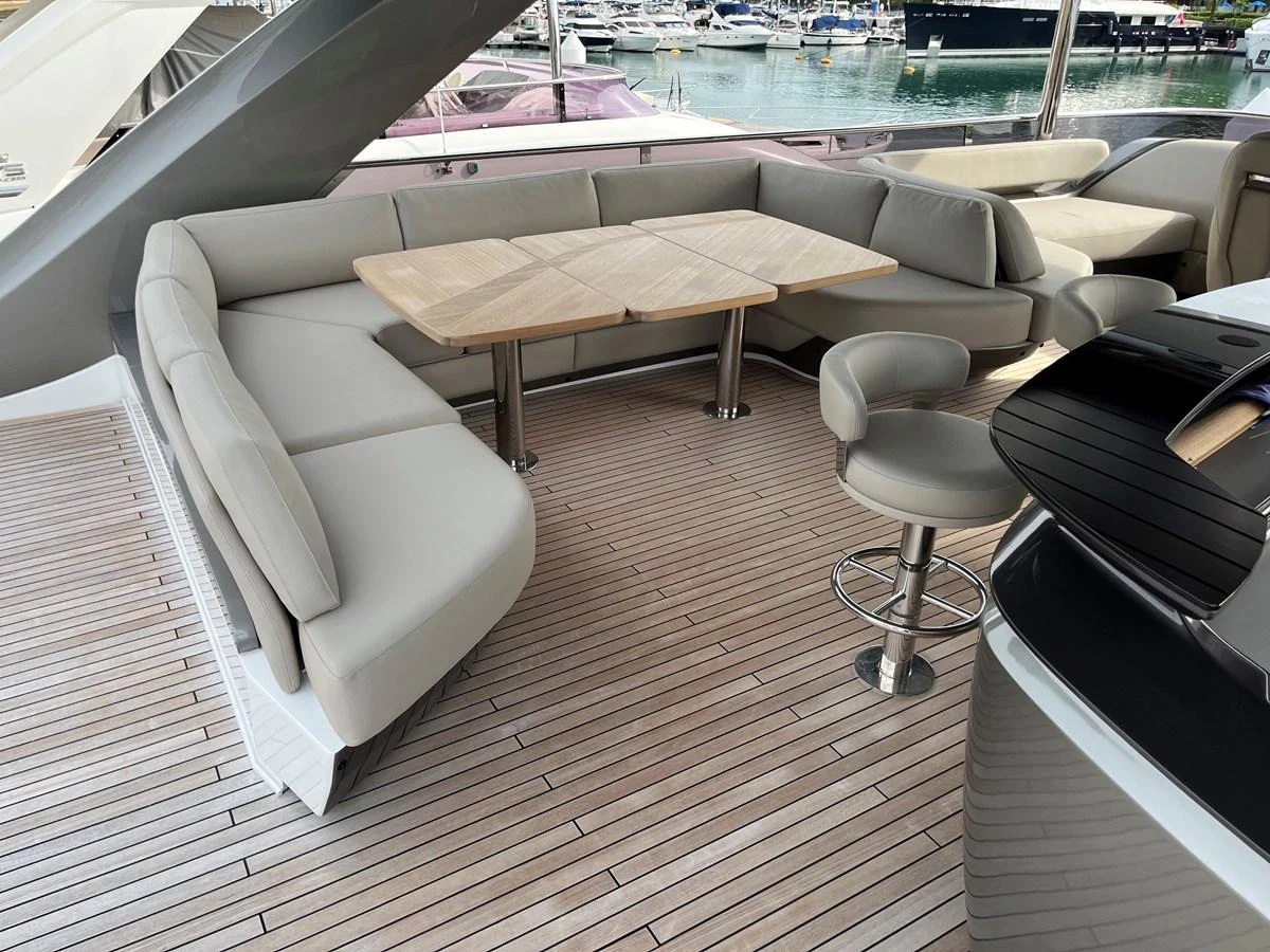 The aft deck features a spacious seating area with a wooden table, perfect for outdoor dining and relaxation. aboard LILYAN Yacht for Sale