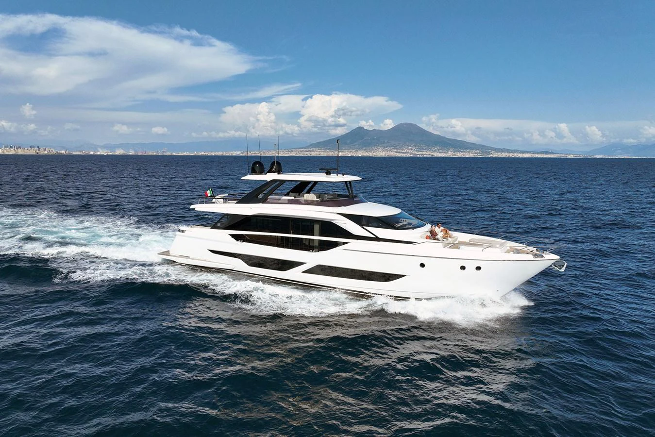 A sleek, modern yacht cruises through the open sea under a clear blue sky. aboard LADY F Yacht for Sale