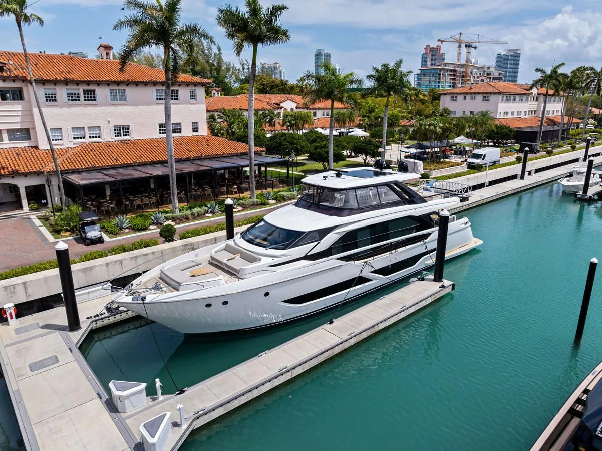 A sleek and modern yacht docked in a marina, showcasing its elegant design and spacious deck. aboard LADY F Yacht for Sale