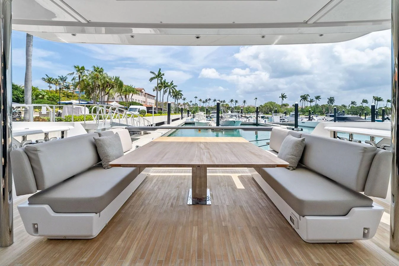 The aft deck features a spacious and inviting dining area with comfortable seating and a beautiful view of the marina. aboard LADY F Yacht for Sale