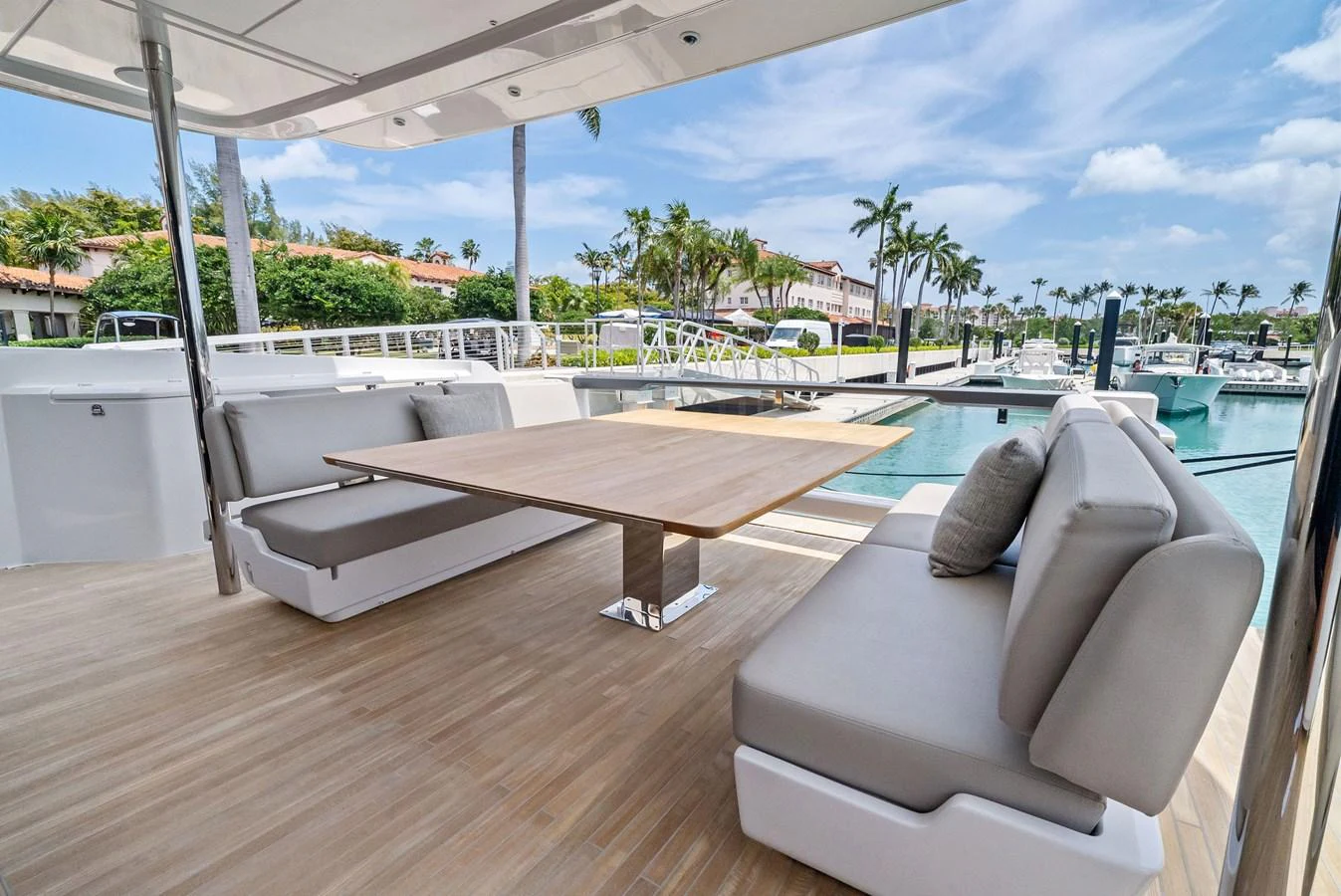 The aft deck features a stylish and comfortable seating area with a wooden table, perfect for alfresco dining. aboard LADY F Yacht for Sale