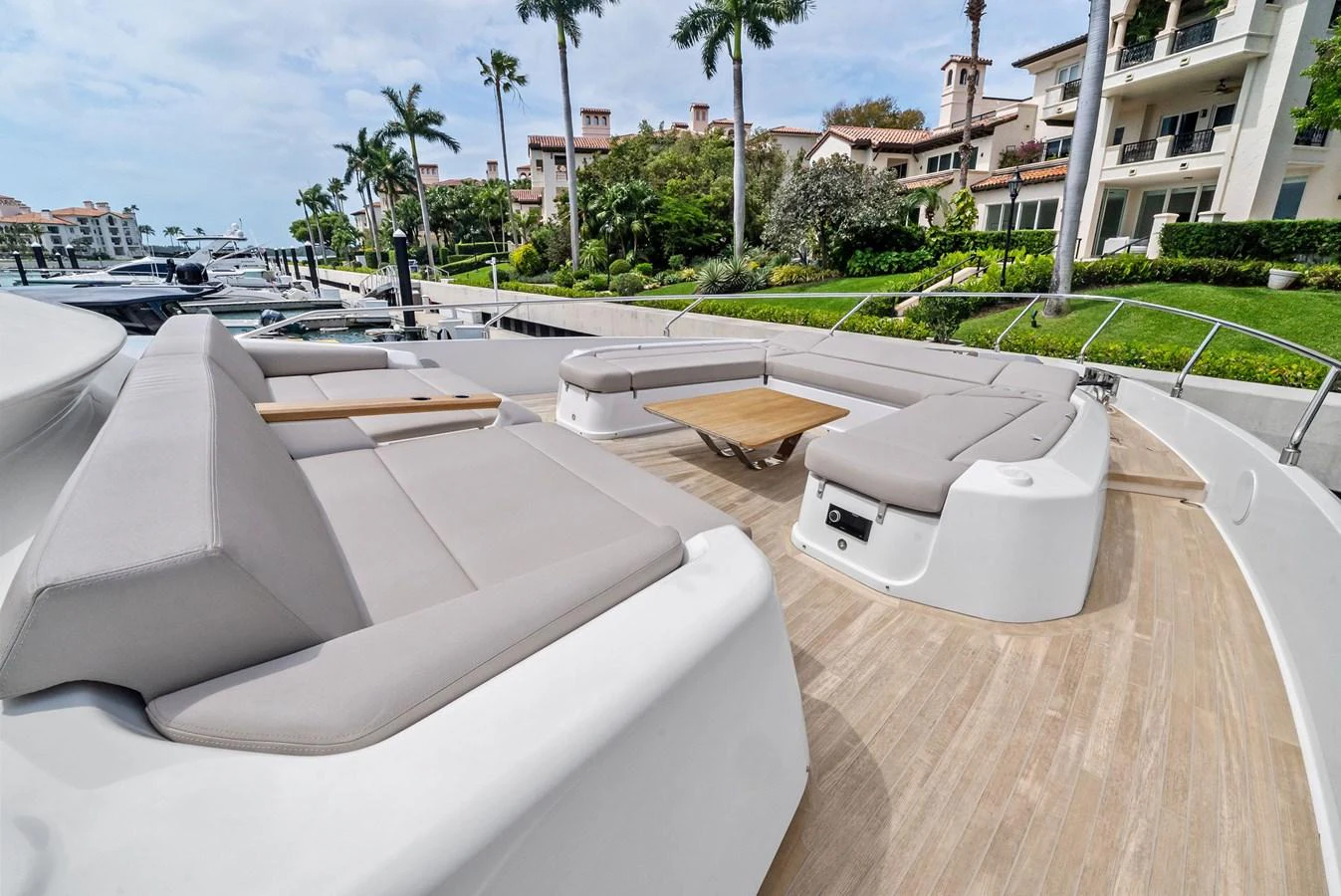 The yacht's foredeck features a spacious seating area with plush cushions and a central wooden table, perfect for relaxation and socializing. aboard LADY F Yacht for Sale