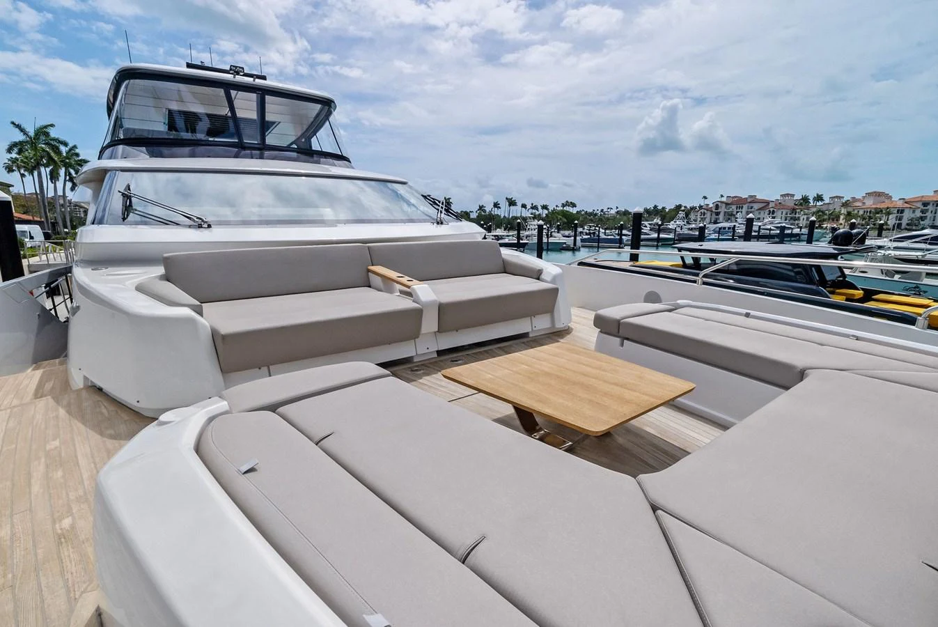 The foredeck features spacious sunpads and a stylish seating area with a wooden table, perfect for relaxation. aboard LADY F Yacht for Sale