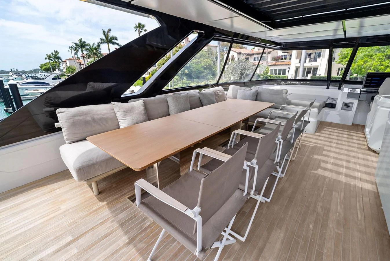 The salon features a spacious seating area with a large table and modern chairs, perfect for socializing and dining. aboard LADY F Yacht for Sale