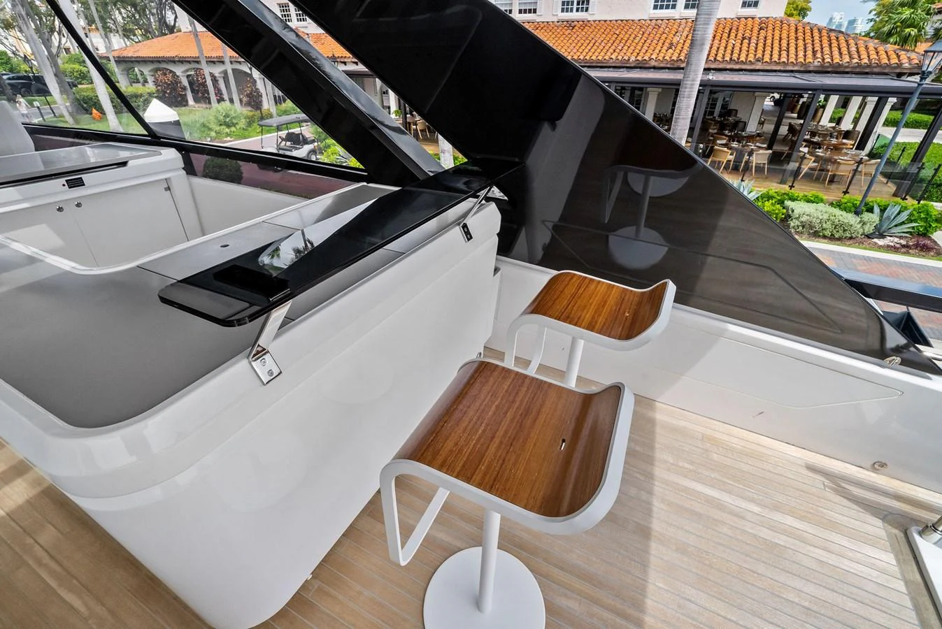 The flybridge features sleek, modern seating and a stylish bar area with a view. aboard LADY F Yacht for Sale