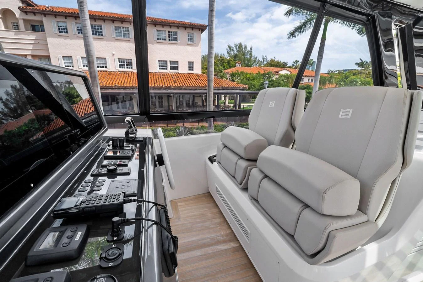 The helm area features plush seating and advanced navigation controls, offering a comfortable and commanding view. aboard LADY F Yacht for Sale