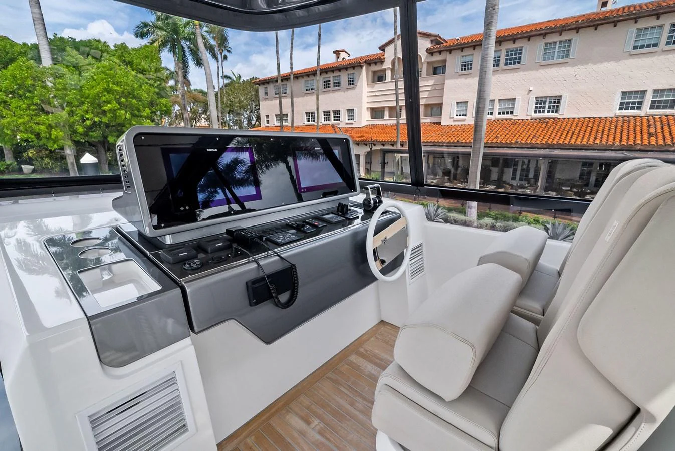 The helm station features modern navigation equipment and a comfortable captain's chair with a scenic view. aboard LADY F Yacht for Sale